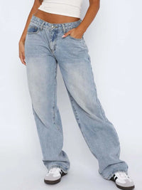 Person wearing light blue jeans on a white background