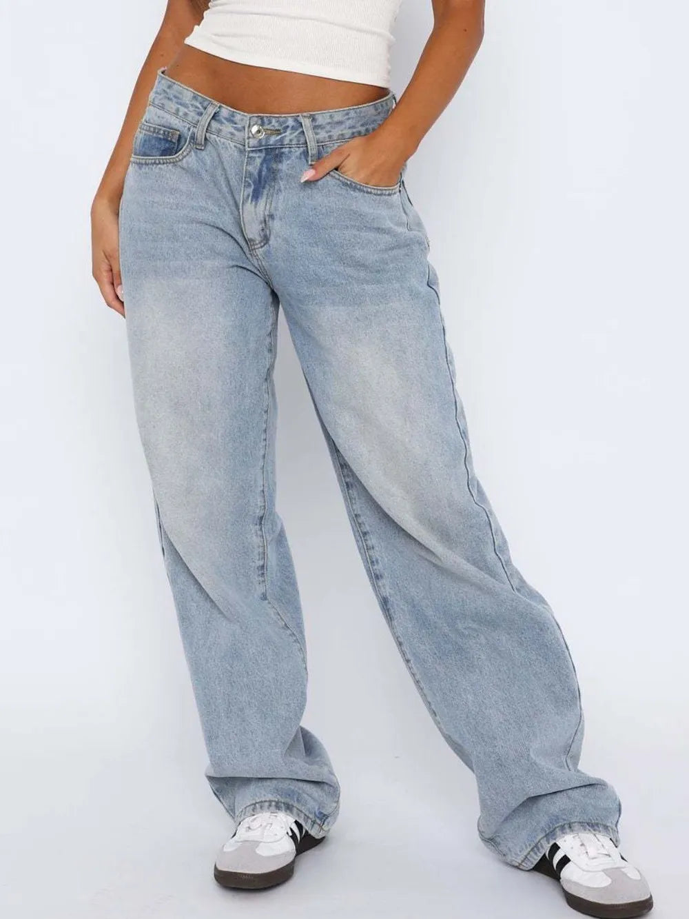 Person wearing light blue jeans on a white background