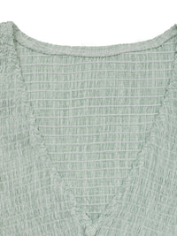 Close-up of a textured green fabric garment
