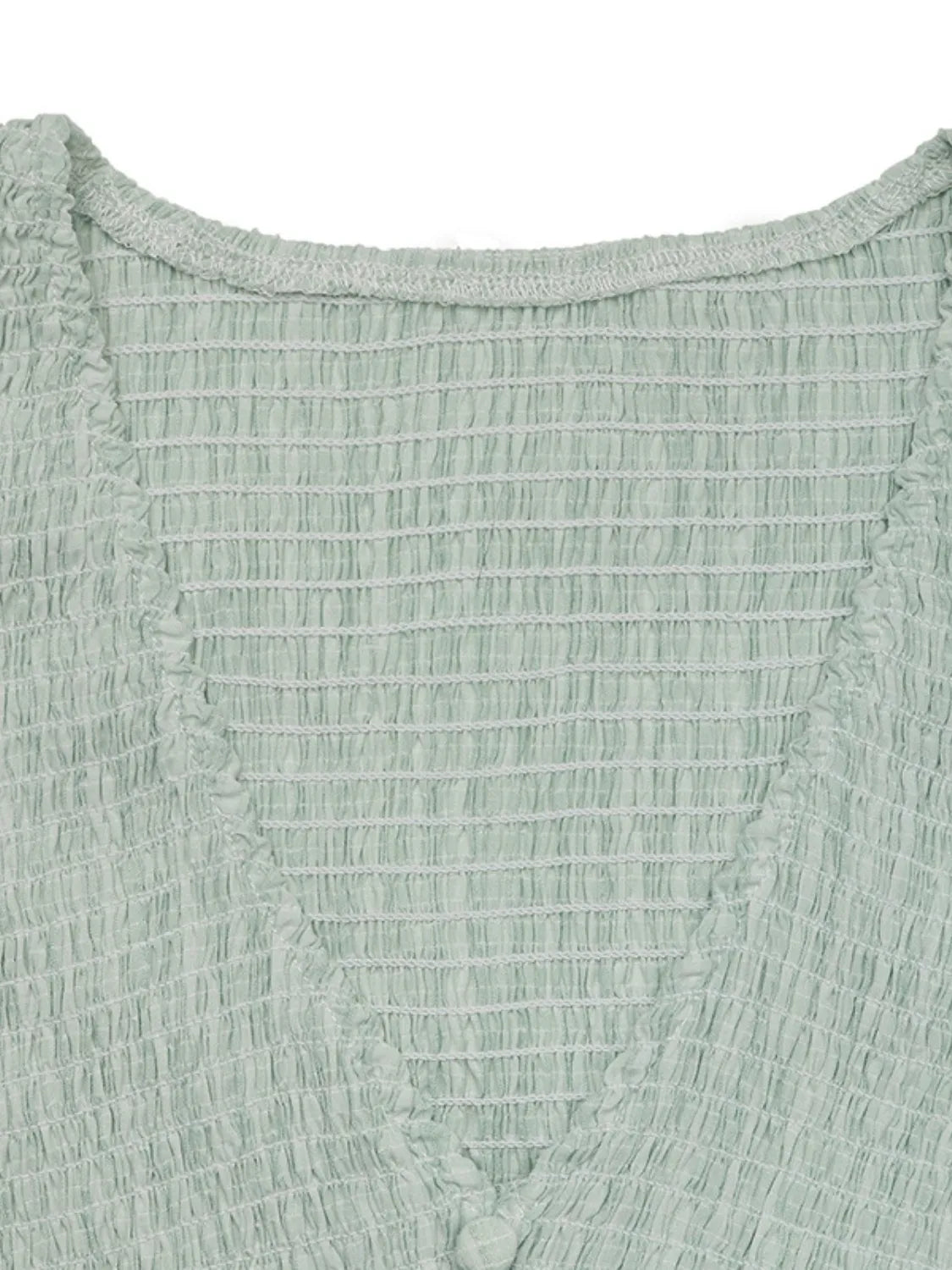 Close-up of a textured green fabric garment