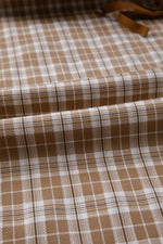 Brown and white checkered fabric with a visible pattern