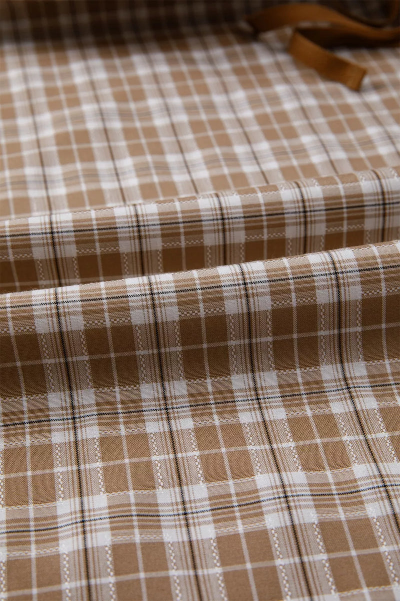 Brown and white checkered fabric with a visible pattern
