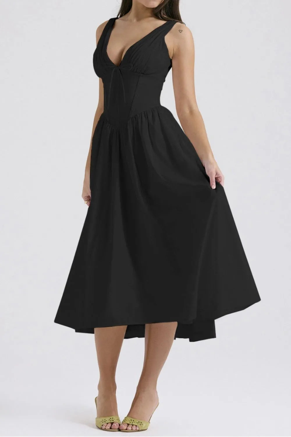 Black dress worn by a model on a white background