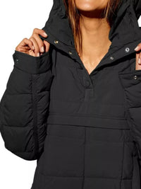 Black puffer jacket worn by a person on a white background