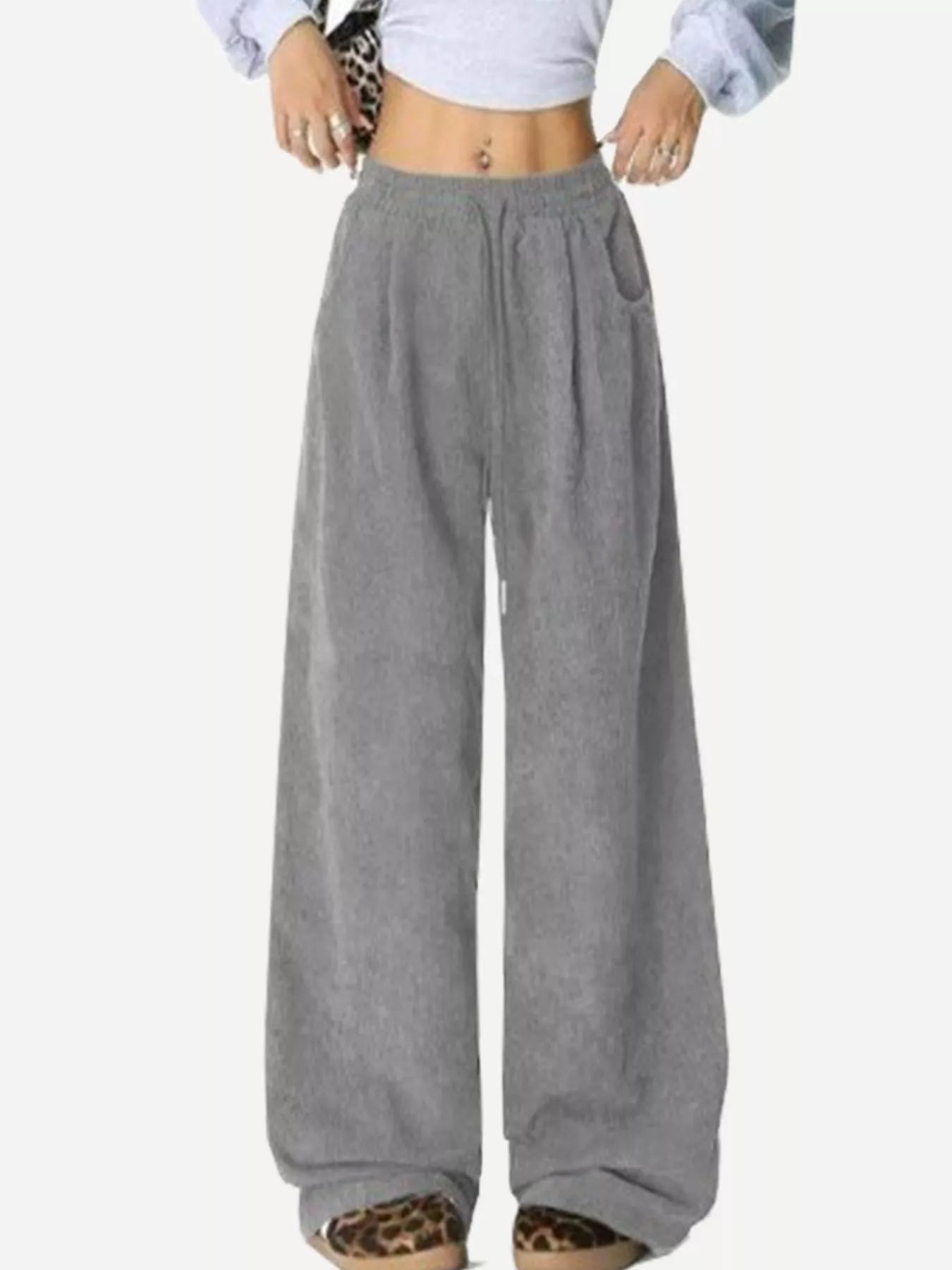 Gray wide-leg pants worn by a person on a white background