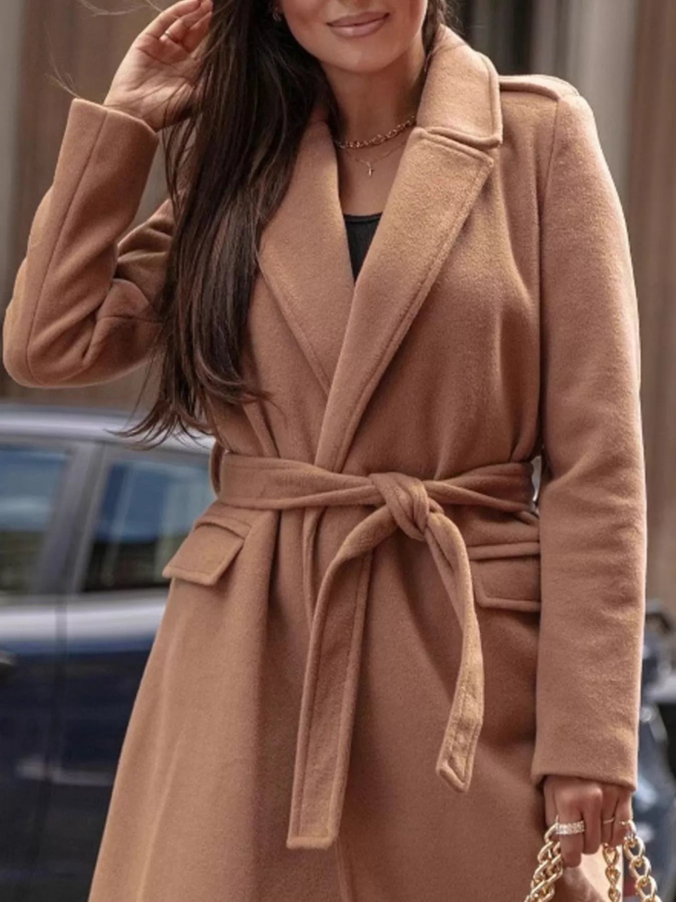 Woman wearing a brown coat with a blurred background
