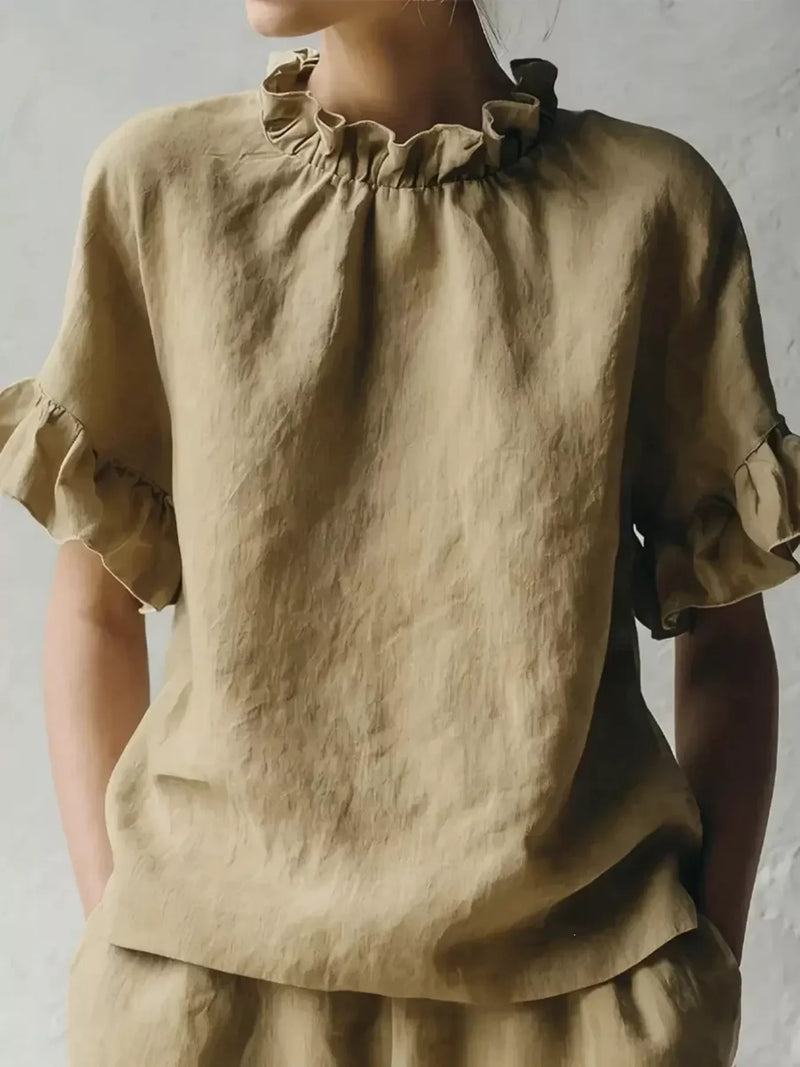 Beige linen blouse with ruffled sleeves on a plain background