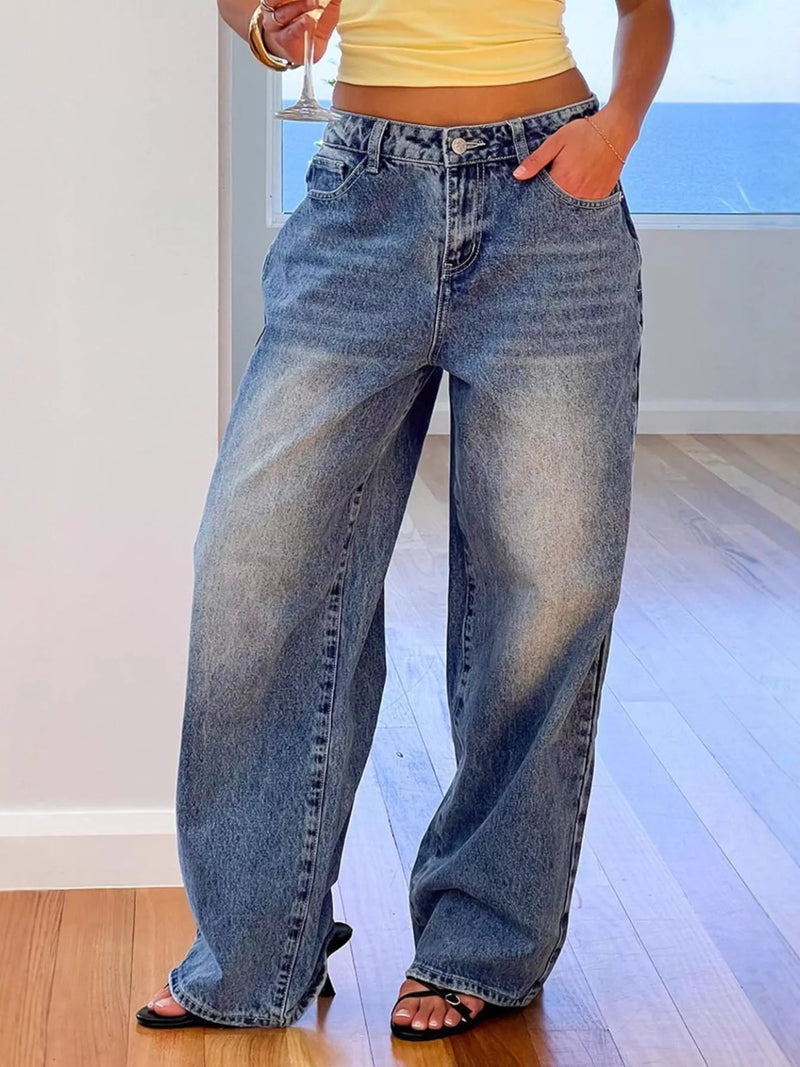 Person wearing blue jeans and a yellow top indoors.
