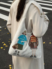 Person wearing a coat with a tote bag featuring cartoon characters on a crosswalk.