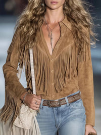 Woman wearing a brown suede fringe jacket with a blurred background