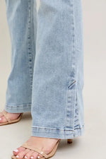 Light blue jeans worn by a person on a neutral background