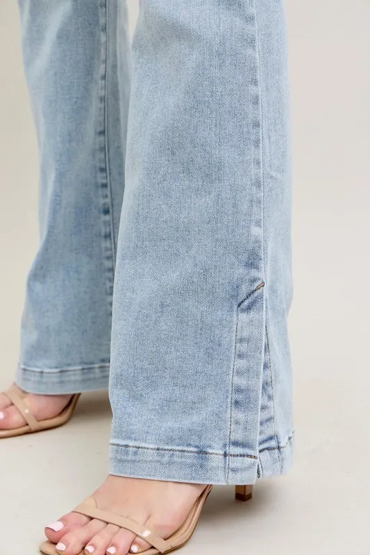 Light blue jeans worn by a person on a neutral background