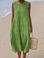 Person wearing a green dress on a beach