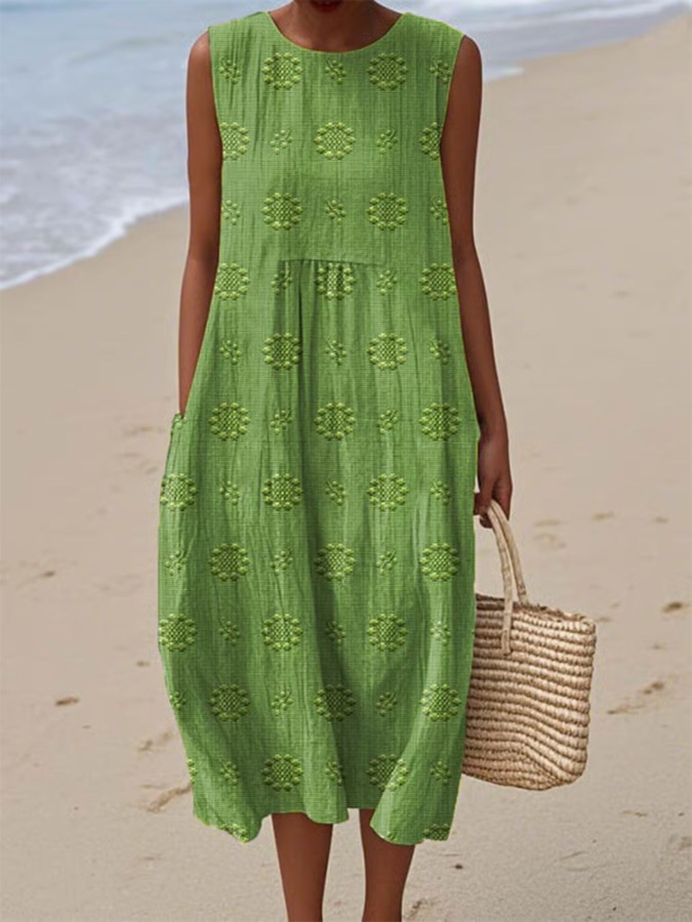 Person wearing a green dress on a beach