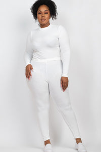 Person wearing a white ribbed knit outfit on a plain background