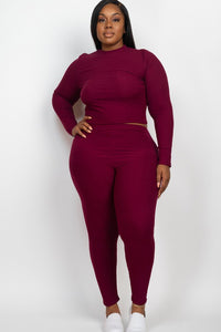 Woman wearing a burgundy matching set on a white background