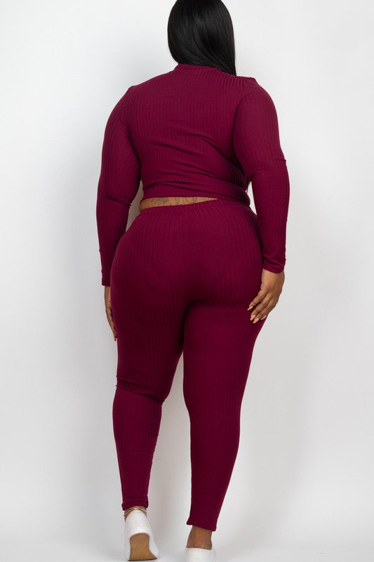 Person wearing a burgundy long-sleeve top and leggings set on a white background