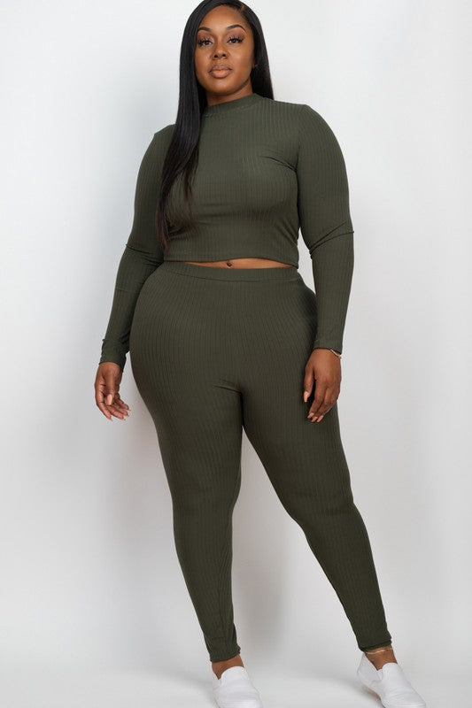 Person wearing an olive green long-sleeve top and leggings set on a white background