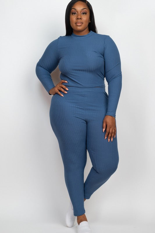Woman wearing a blue ribbed jumpsuit on a white background