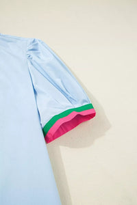 Light blue fabric with a colorful trim on a beige background