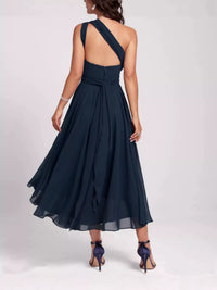 Navy blue dress with a flowing skirt on a white background