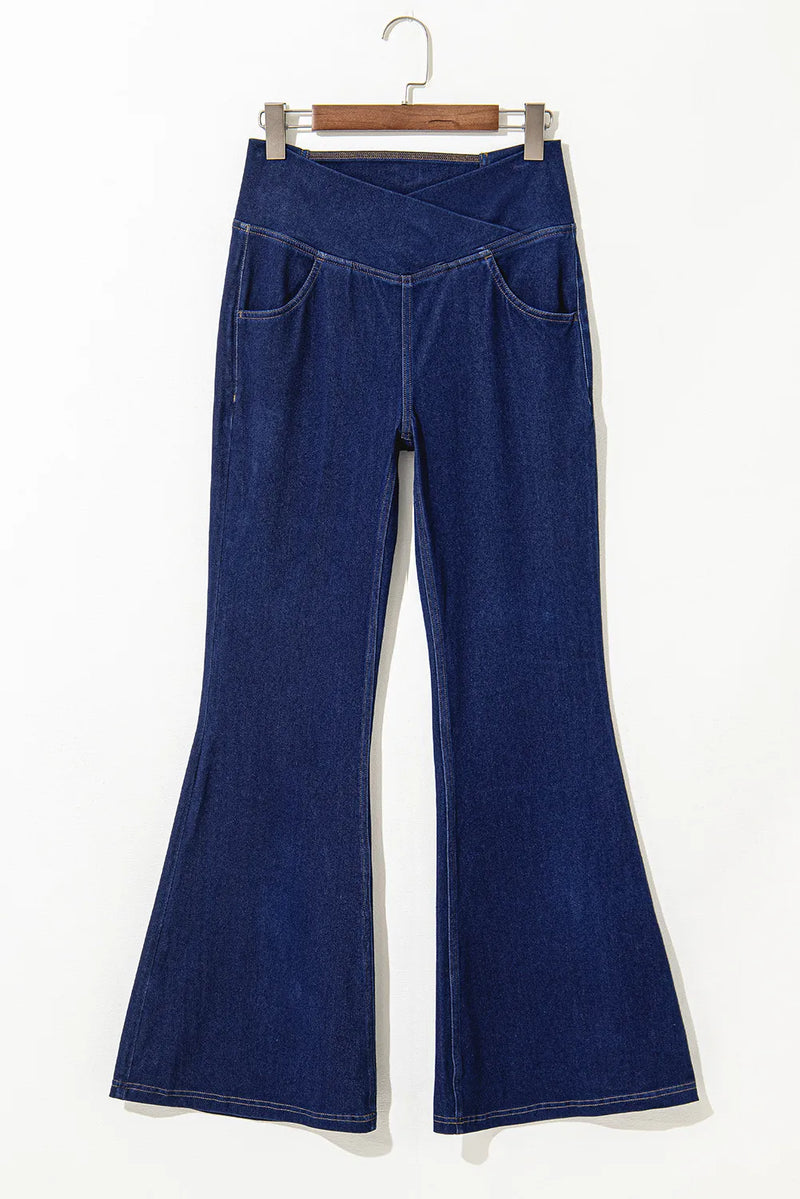 Blue jeans on a hanger against a white background