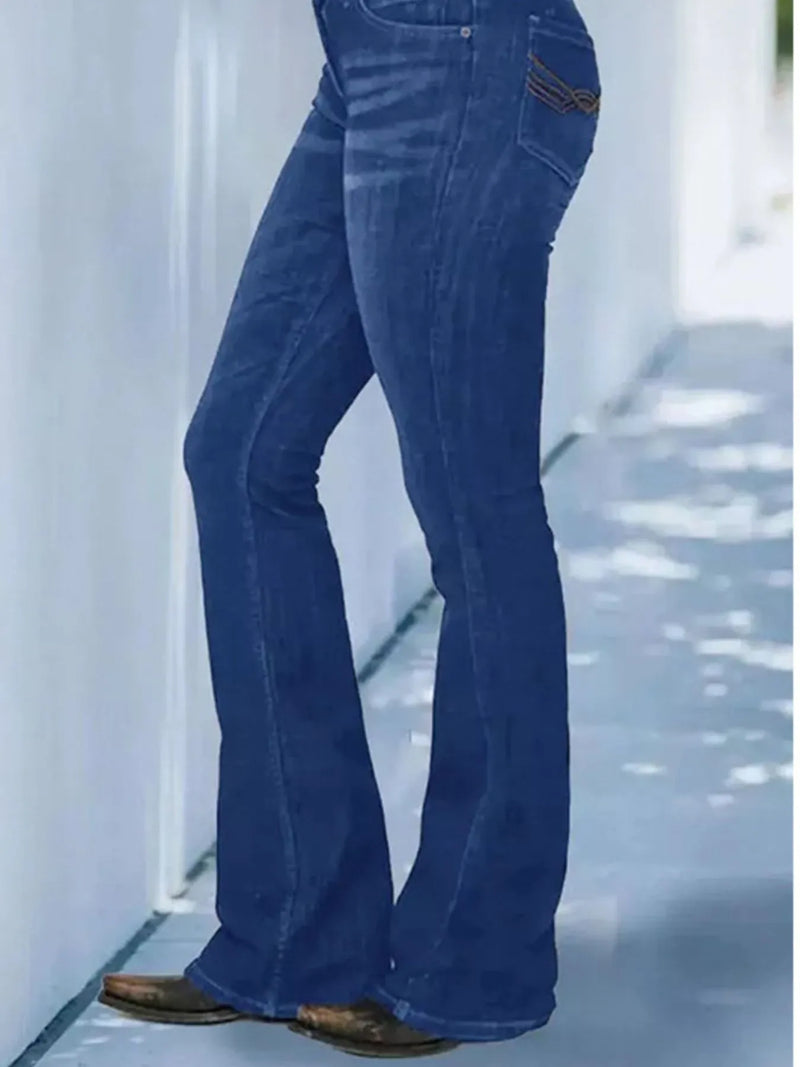 Blue jeans worn by a person on a light background