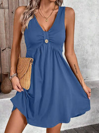 Woman wearing a blue dress with a wooden background