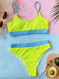Neon green bikini set with blue straps on a pink and blue background.