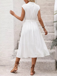Woman wearing a white dress on a light background