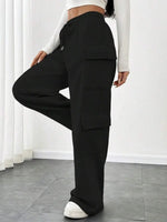 Person wearing black cargo pants with a white background