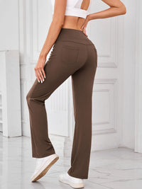 Brown pants worn by a person in a minimalistic setting