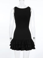 Black dress with ruffled hem on a mannequin against a white background