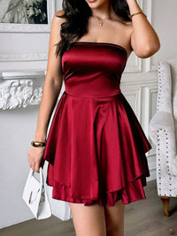 Woman wearing a red strapless dress in an indoor setting