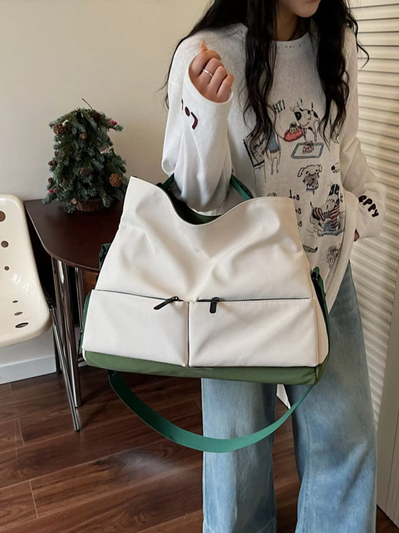 Person holding a white and green bag in an indoor setting