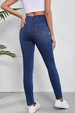 Person wearing blue jeans with a white background