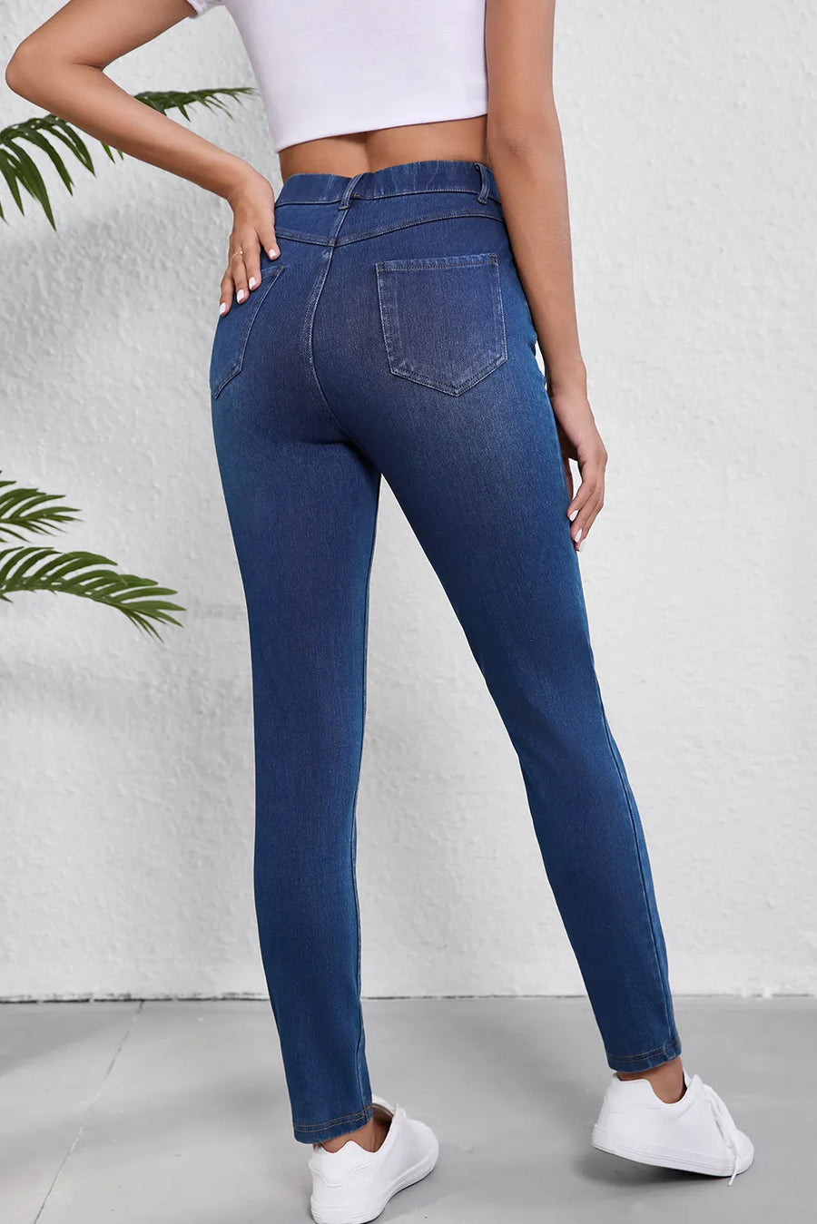 Person wearing blue jeans with a white background