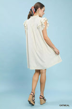 Woman wearing a white dress against a light blue background