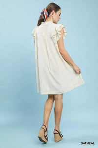 Woman wearing a white dress against a light blue background