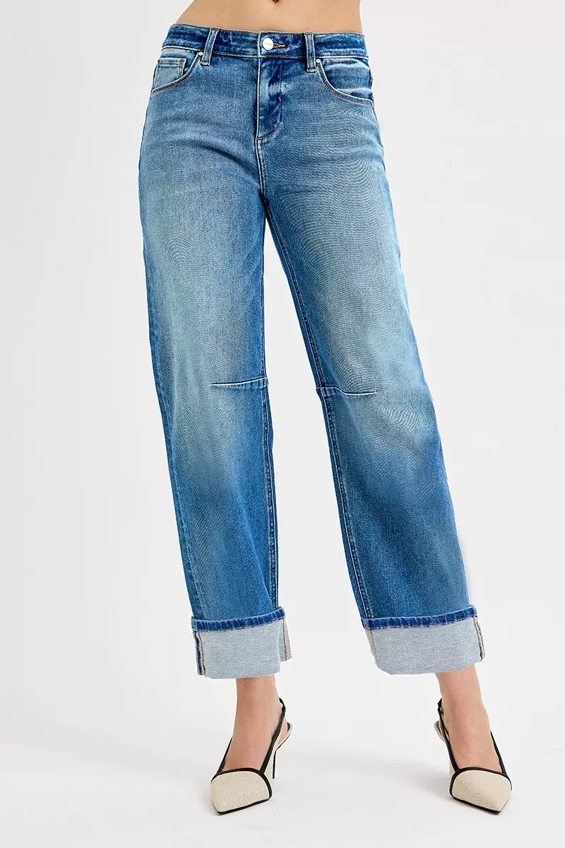 Blue jeans worn by a person on a white background