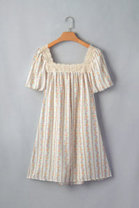 Floral dress on a hanger against a gray background