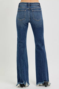 Blue jeans with frayed hem on a white background