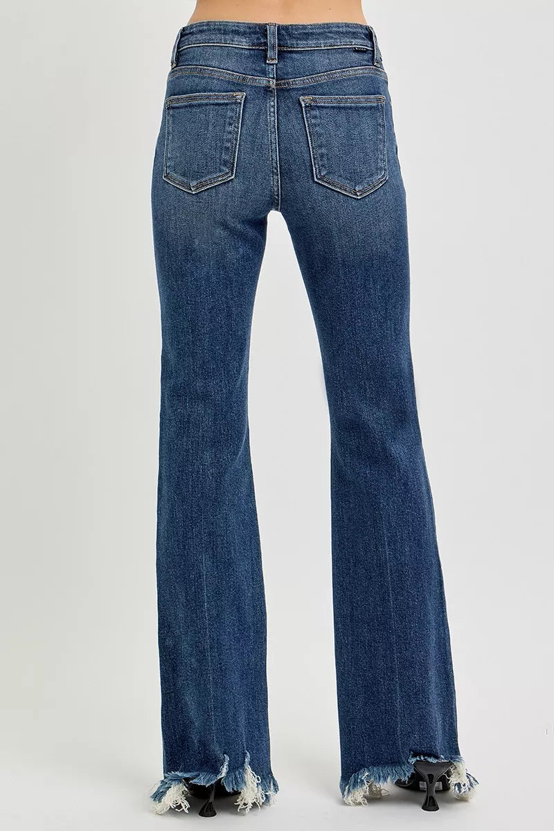 Blue jeans with frayed hem on a white background