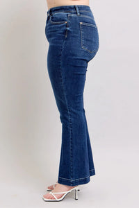 Blue flared jeans on a plain background
