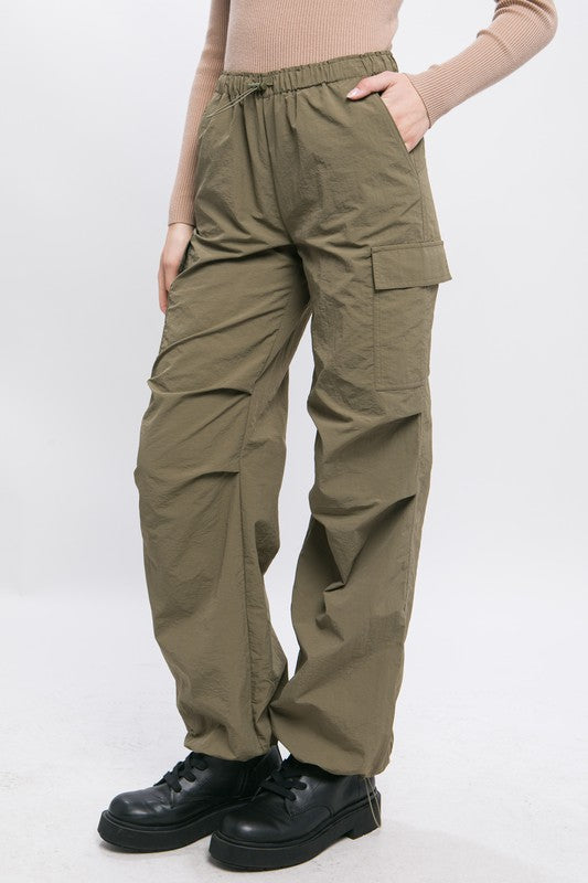 Model showing side pocket on Loose Fit Parachute Cargo Pants-olive