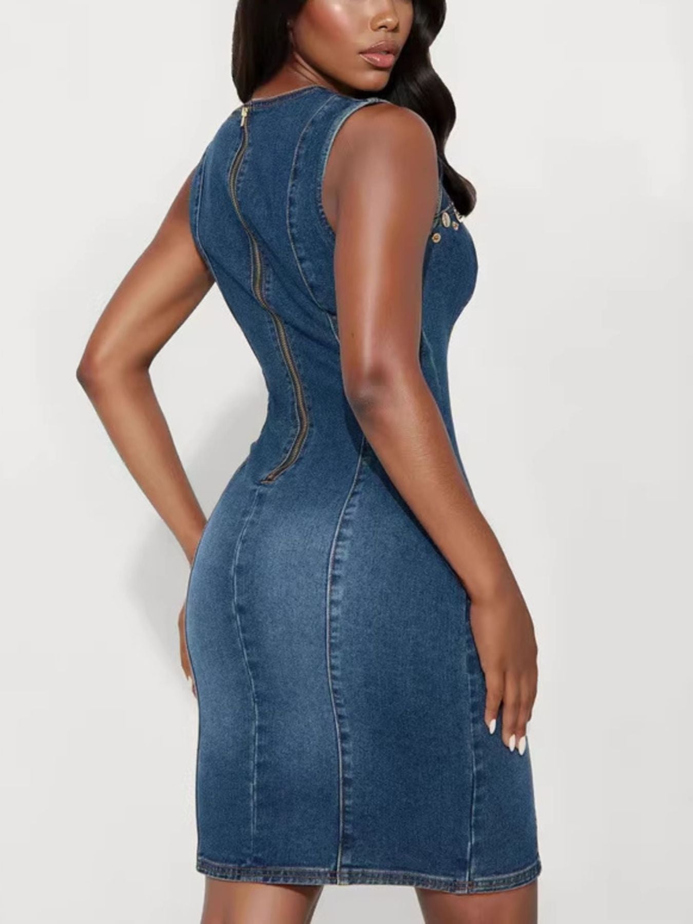 Woman wearing a blue denim dress on a white background