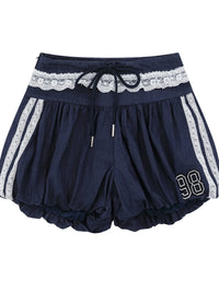Navy blue shorts with lace waistband and white stripes on a white background