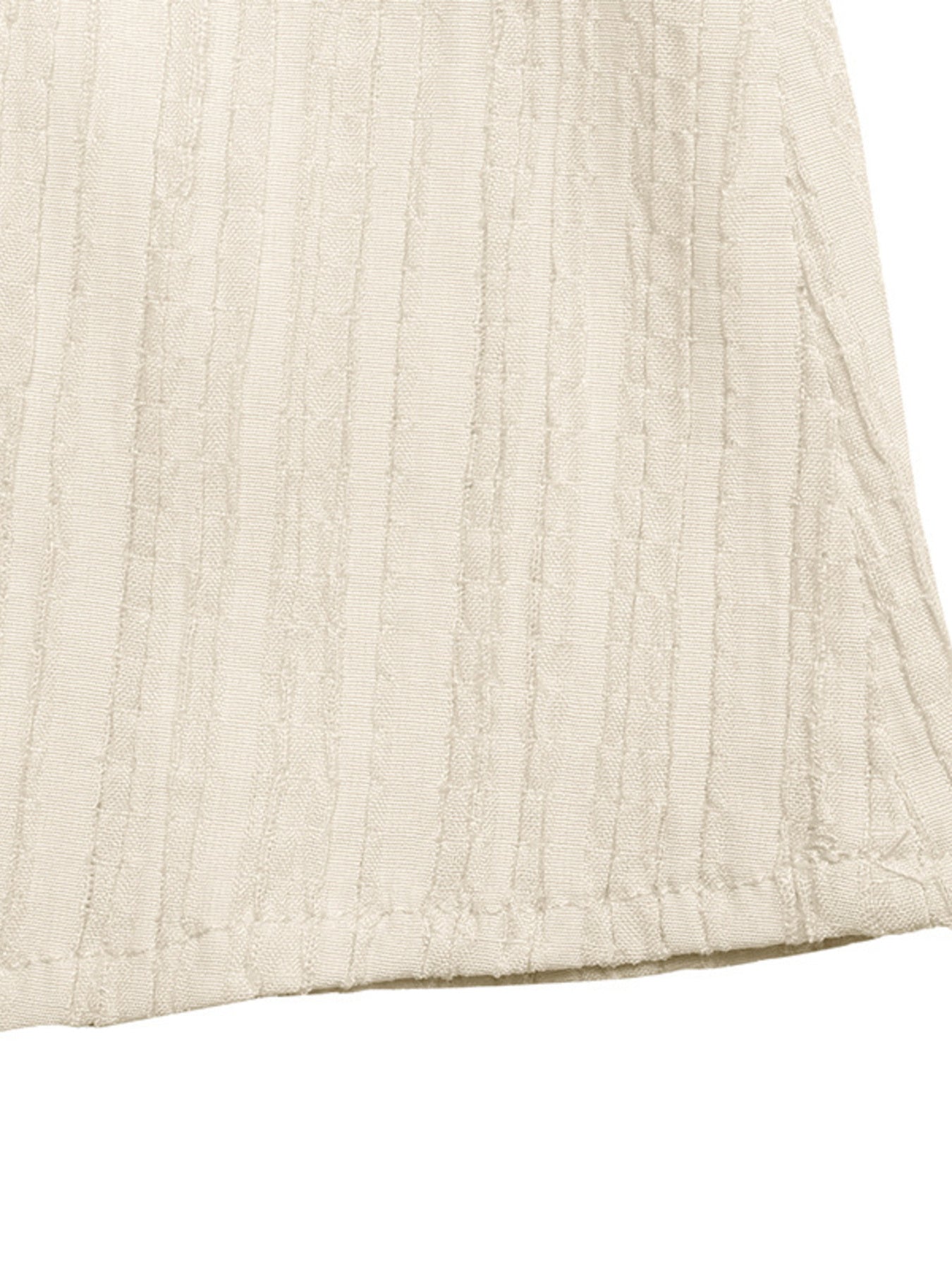Close-up of a textured beige fabric corner on a white background