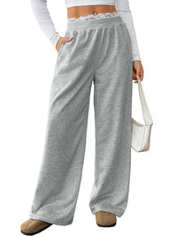 Gray wide-leg pants worn by a person on a white background