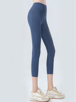 Blue leggings worn by a person on a white background